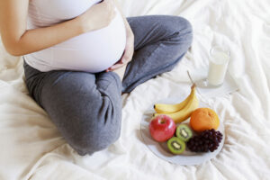 Pregnant woman eating a nutritious snack at home